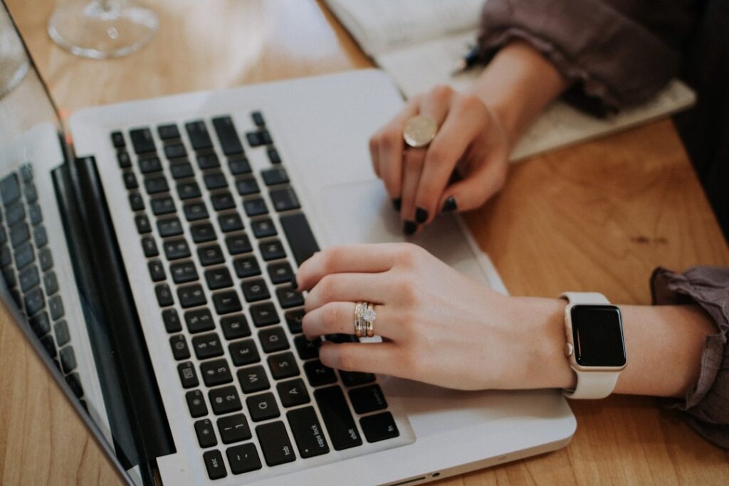 A woman typing on a laptop, emphasizing Customer Journey Automation for effective engagement.