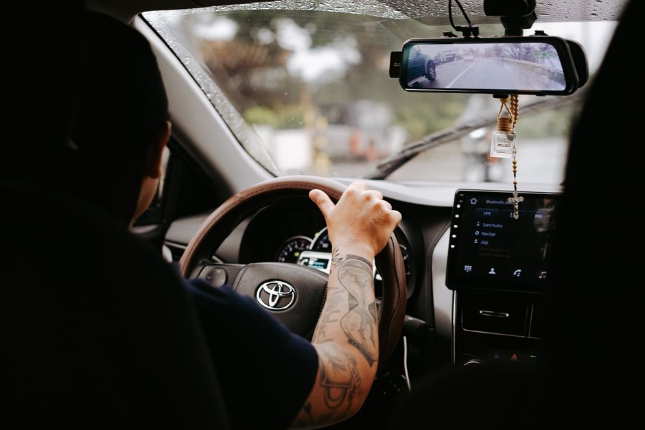 Toyota vehicle with active safety features navigating busy Florida highway traffic under sunny skies