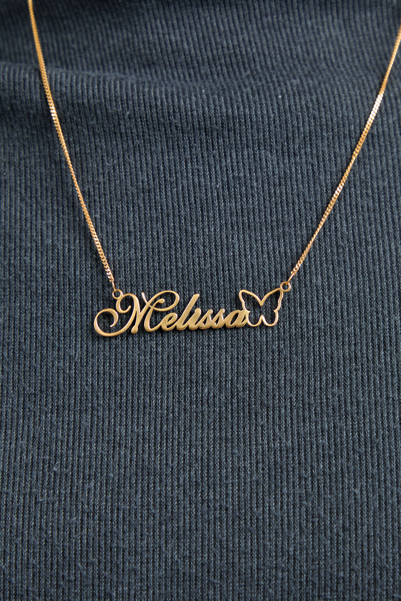 A personalised gold vermeil name necklace, made to order in the UK
